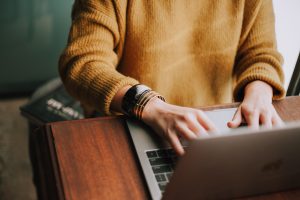 woman typing on keyboard, blog content repurposing, content creation