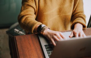 woman typing on keyboard, blog content repurposing, content creation