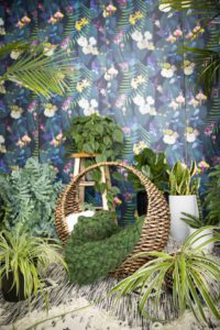 round basket in front of a dark floral backdrop surrounded