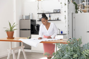 realtor looking over blueprints in a white kitchen