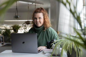 a photographer works on her computer in a coworking space in fairmont wv