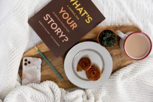 a fall themed flatlay on a white bed