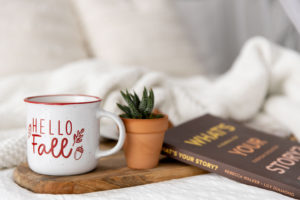 a fall themed photo set on a white bed