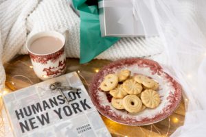 a christmas flatlay on a white bed